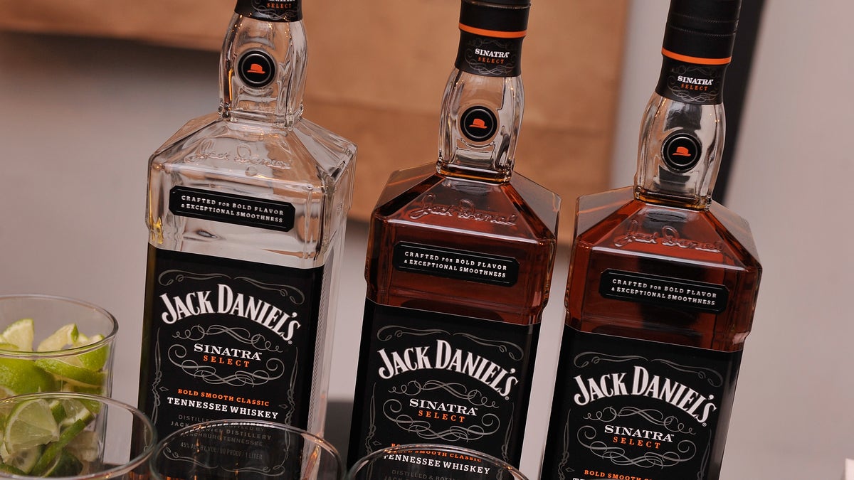 Jack Daniels bottles lined up at a bar.