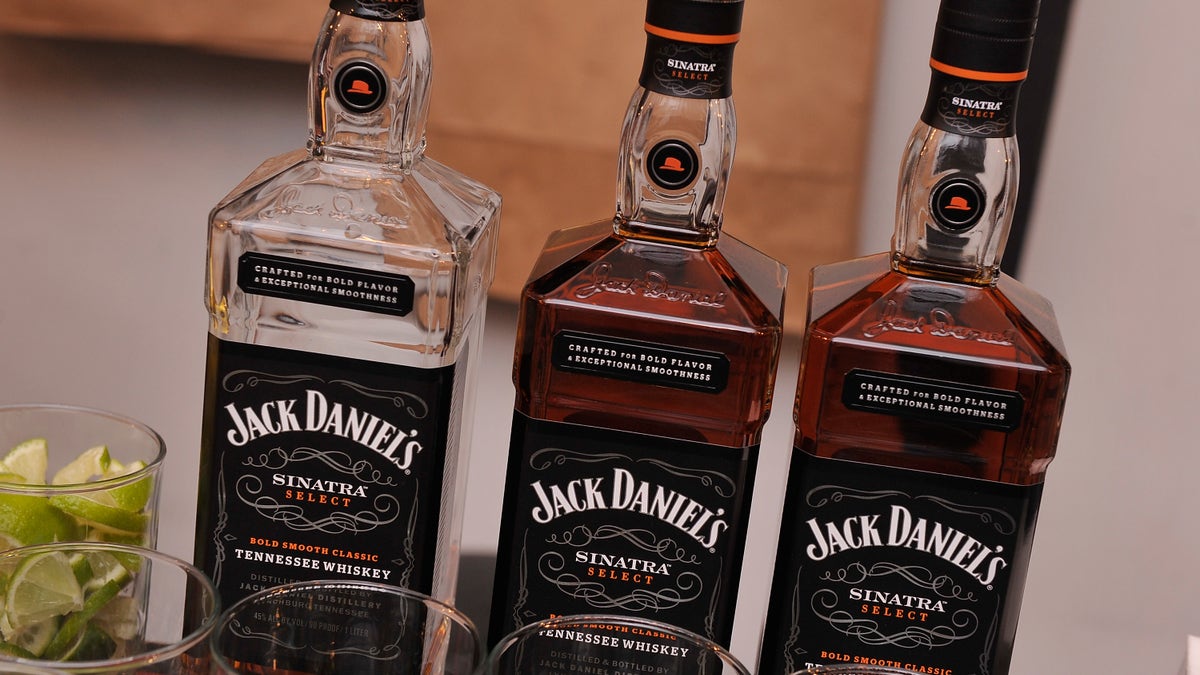 Jack Daniels bottles lined up at a bar.