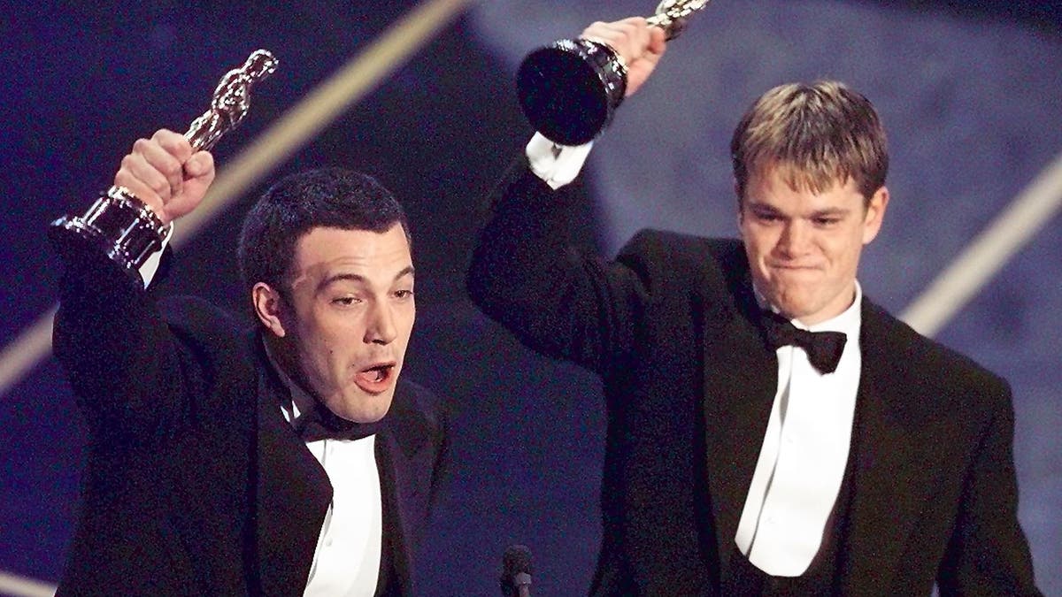 Ben Affleck and Matt Damon hold their Oscars on stage