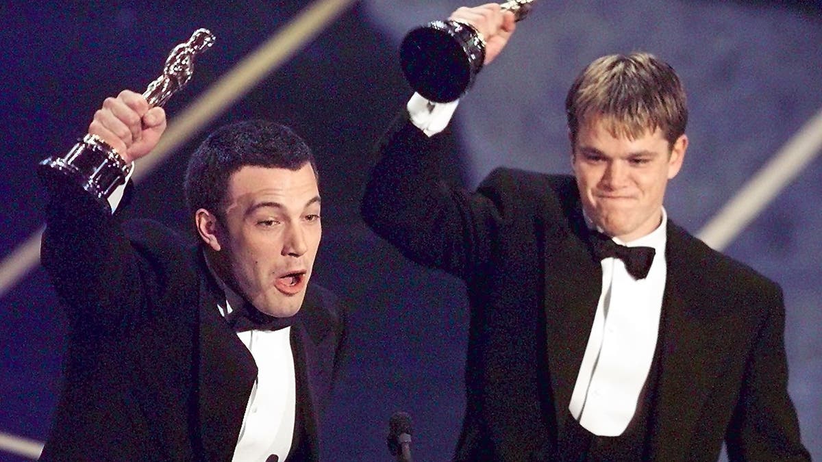 Ben Affleck and Matt Damon hold their Oscars on stage