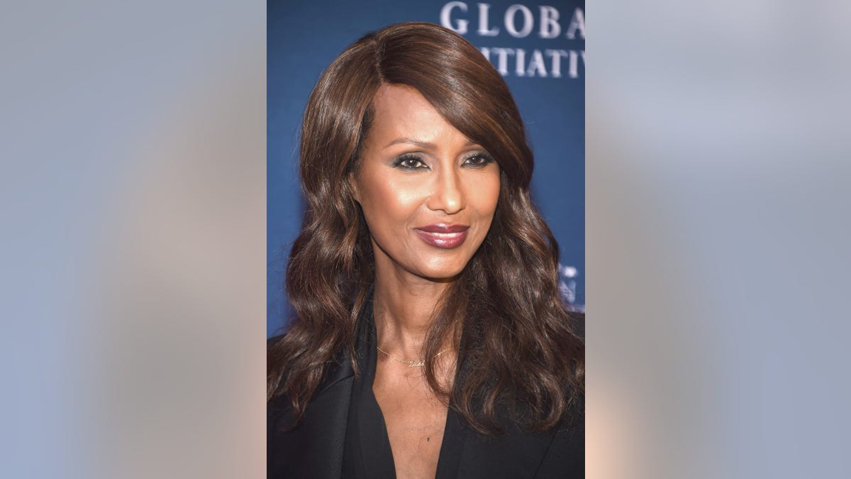 Iman wearing David necklace and black suit