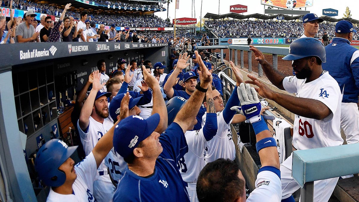 Andrew Toles celebrates scoring on a single