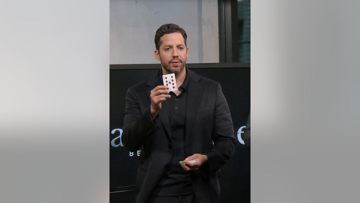 David Blaine holds up a card