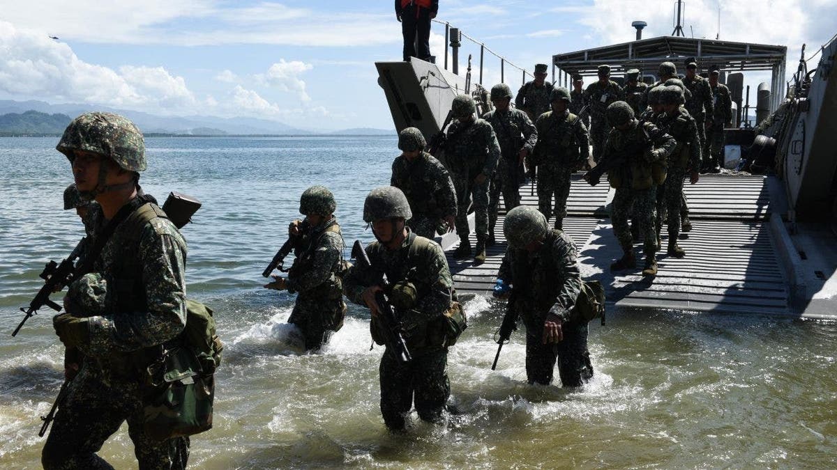 Philippine marines exit landing craft in exercise