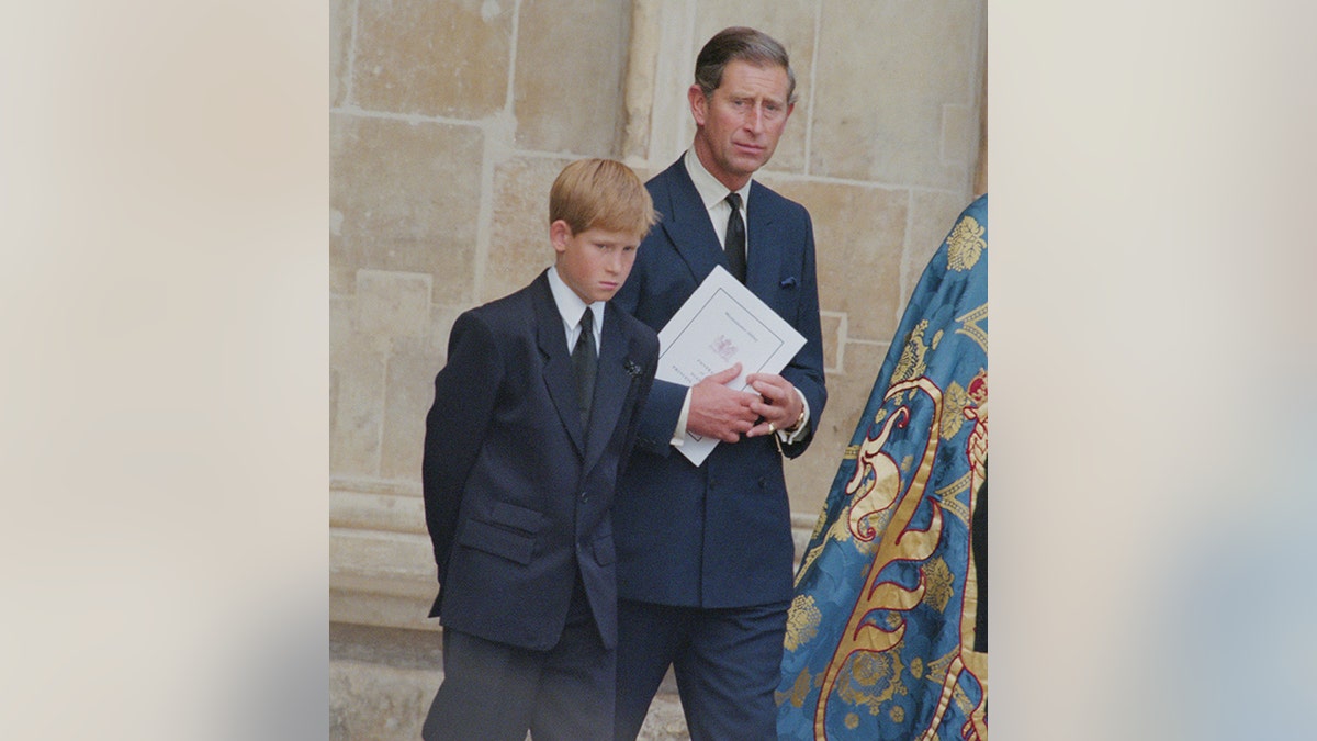 Prince Harry and the now King Charles holding something at Westminster Abbey for the funeral service of Princess Diana