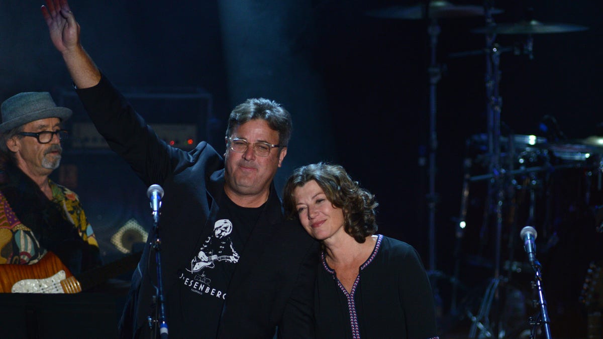 Vince Gill Waving on stage with Amy Grant