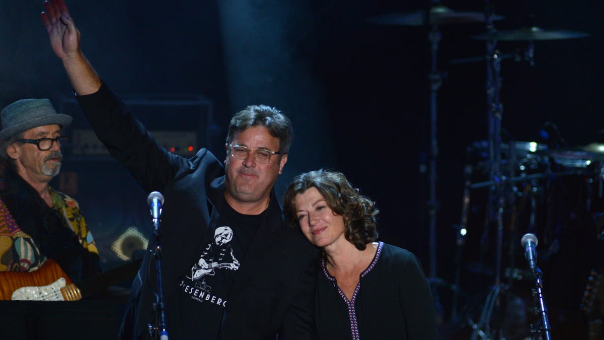 Vince Gill Waving on stage with Amy Grant