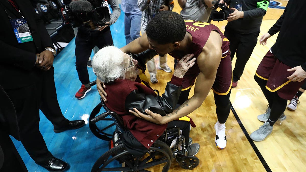Aundre Jackson hugs Sister Jean during the 2018 March Madness tournament