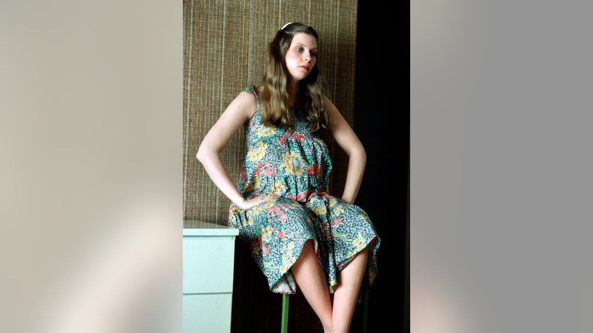 Bebe Buell heavily pregnant wearing a floral dress