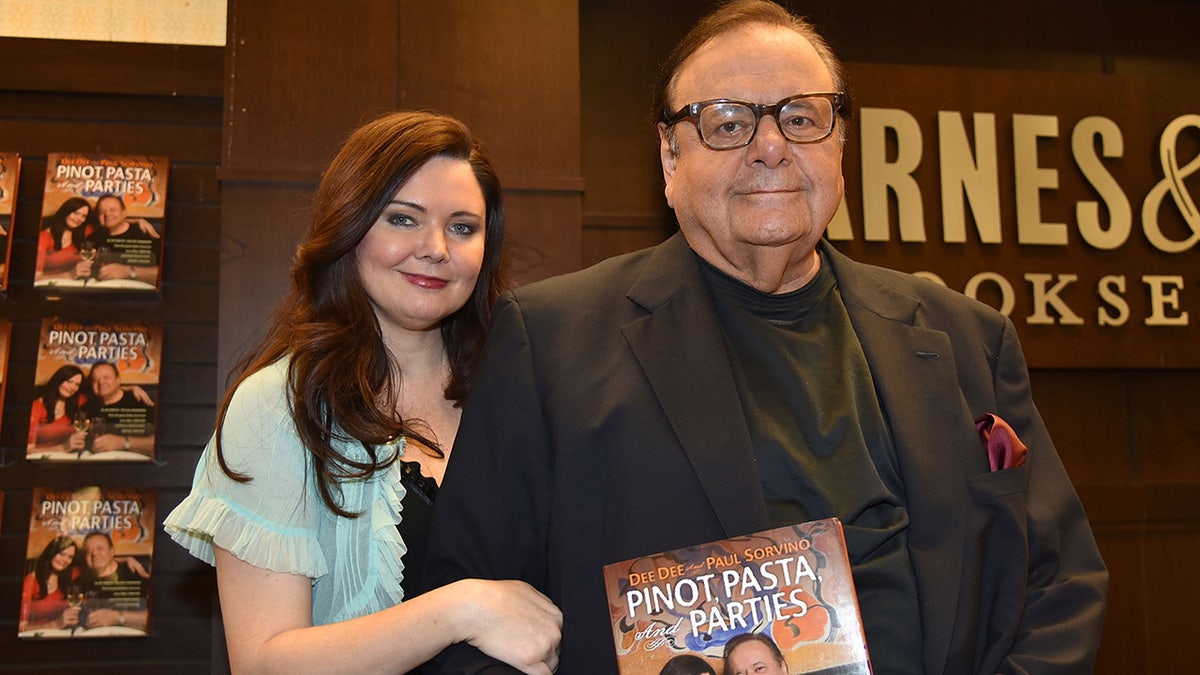 Dee Dee Sorvino holding onto her husband Paul Sorvino at a book launch