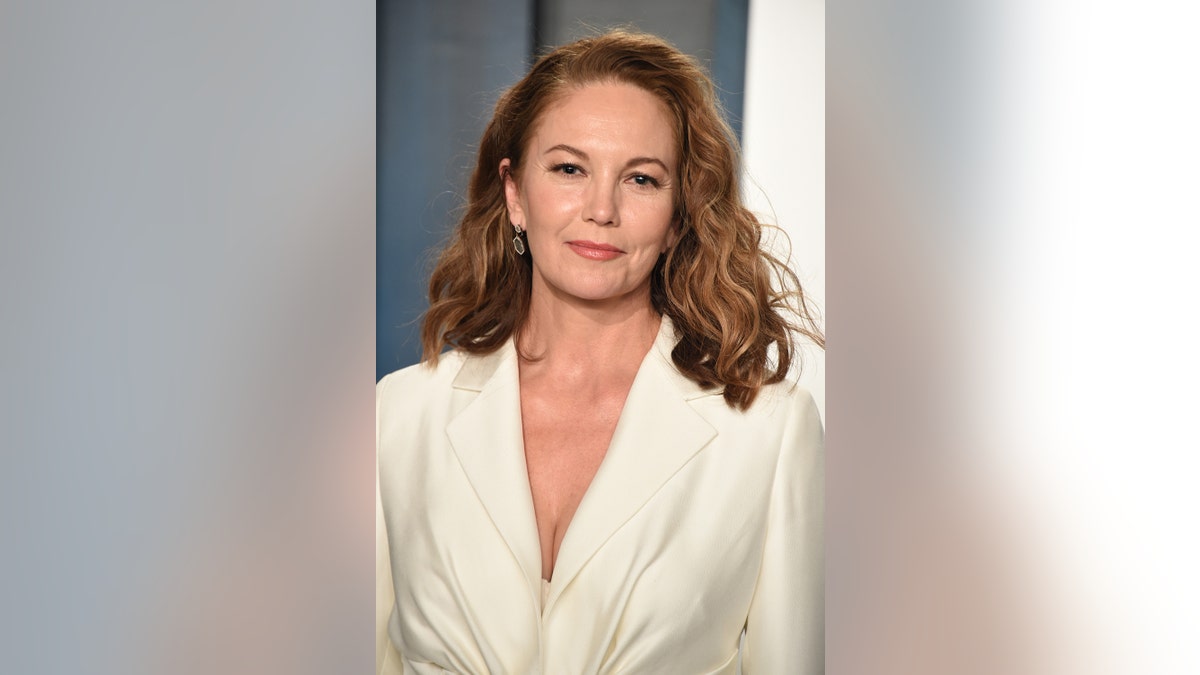 A close-up of Diane Lane wearing a white pantsuit