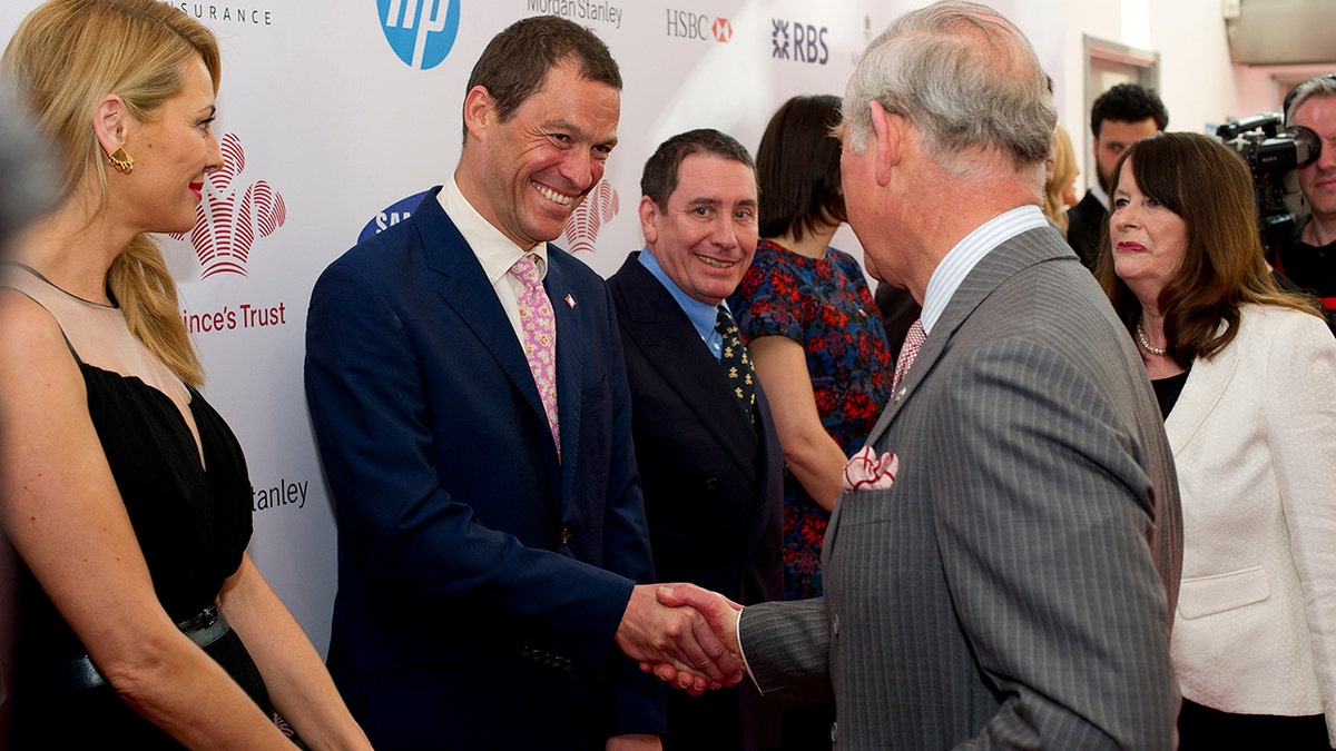 Dominic West shaking Prince Charles' hand at a function