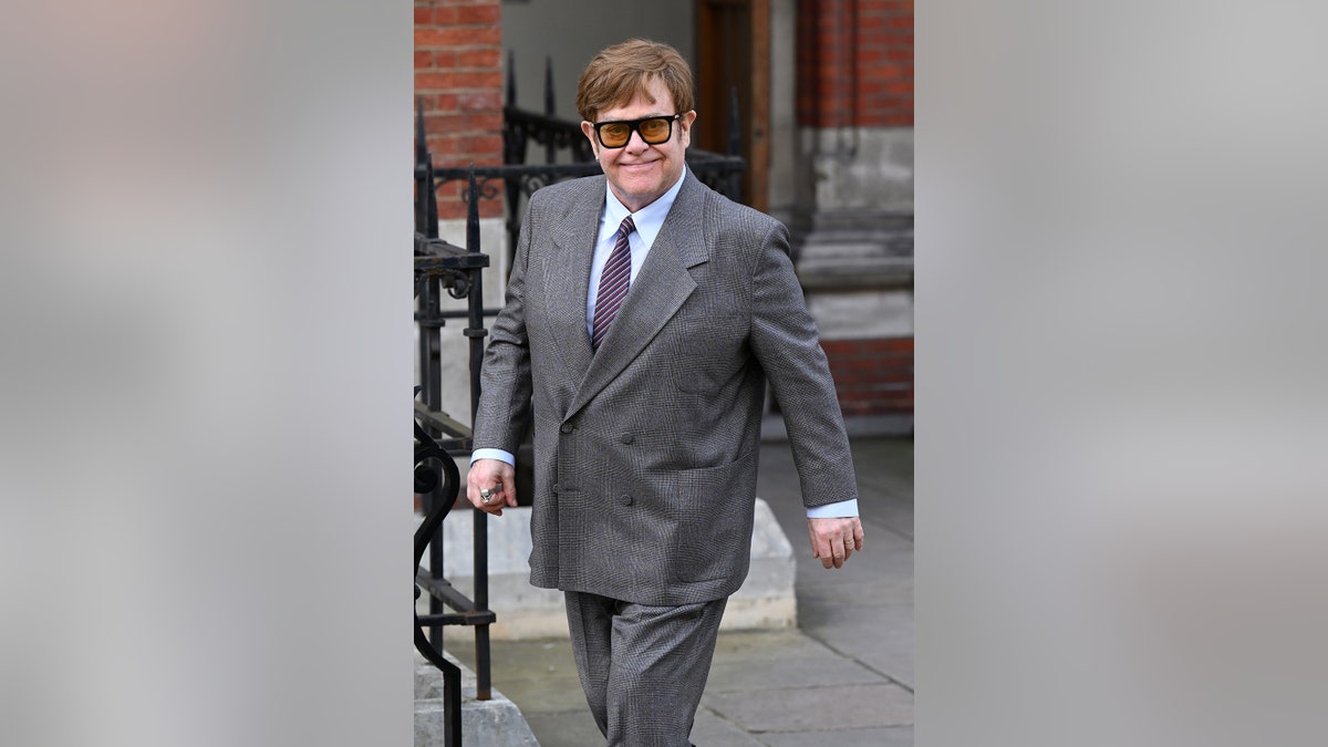 Elton John in a grey suit outside of High Court in London