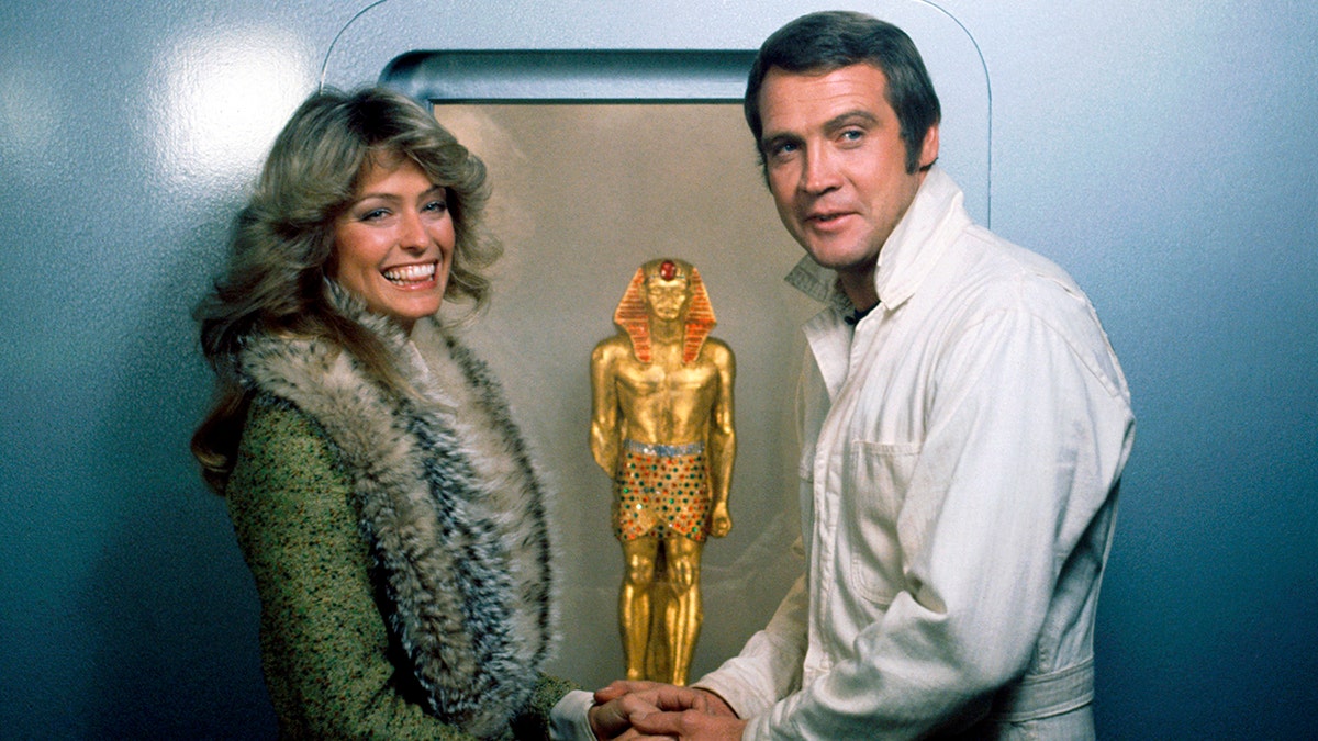 Farra Fawcett in a fur coat filming a TV scene with her former husband Lee Majors