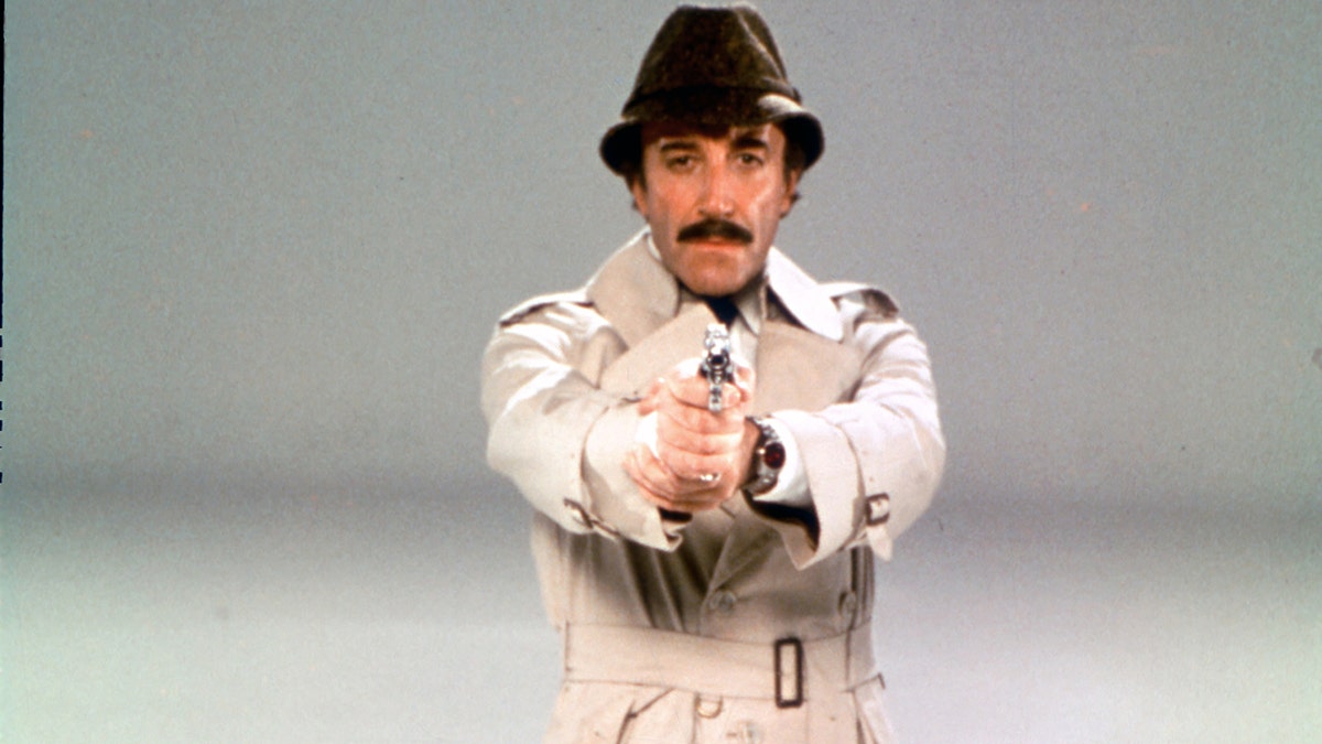 Photo of Peter Sellers as Inspector Clouseau holding a gun