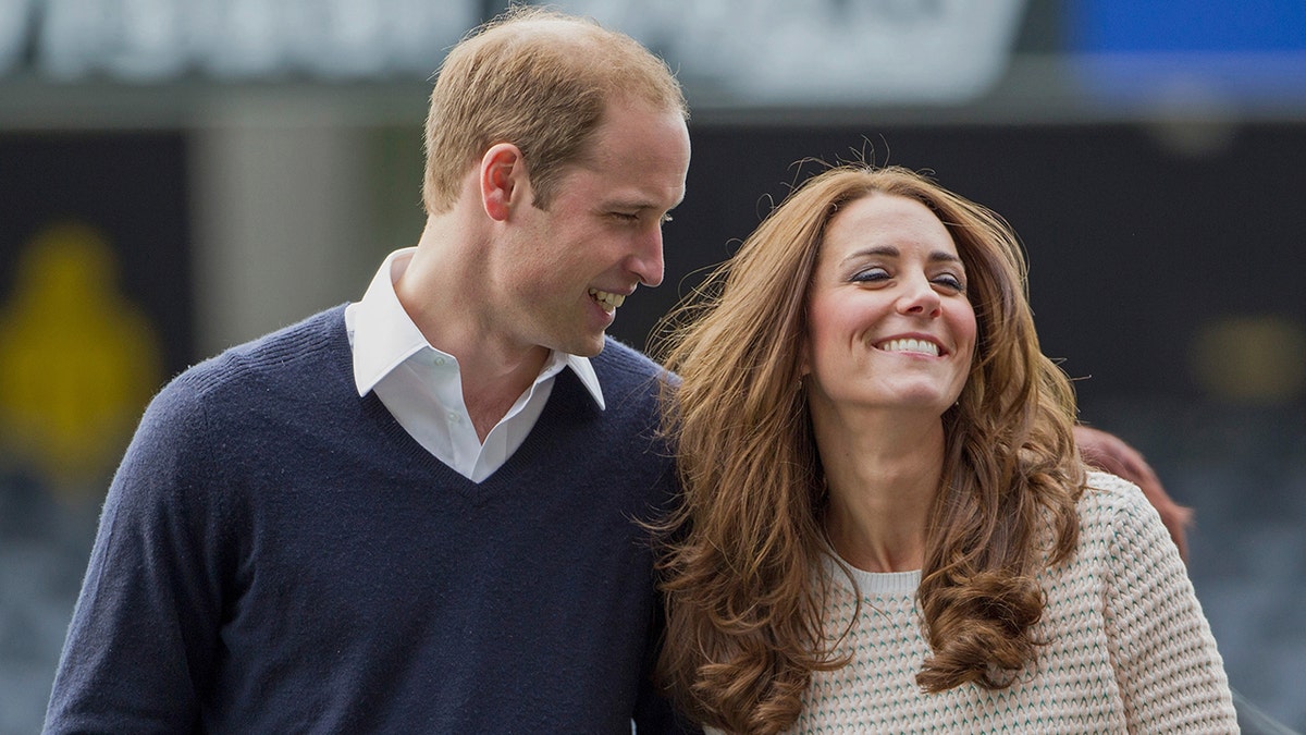 Prince William looking at a smiling Kate Middleton during a royal engagement
