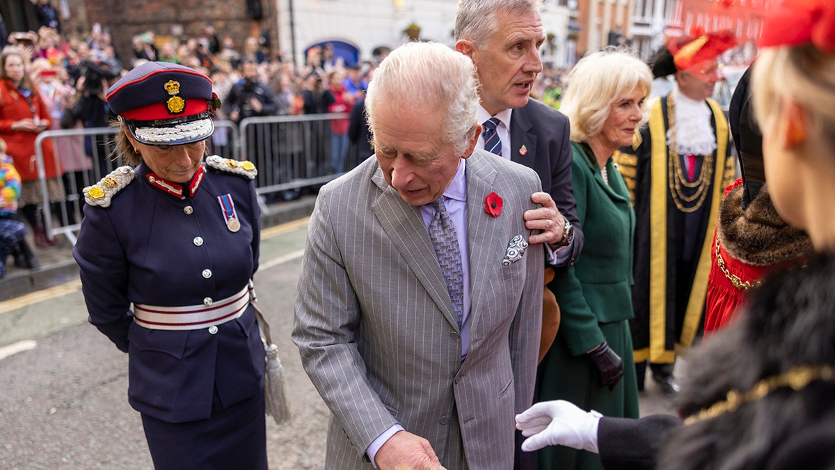 King Charles looking to see where a thrown egg came from