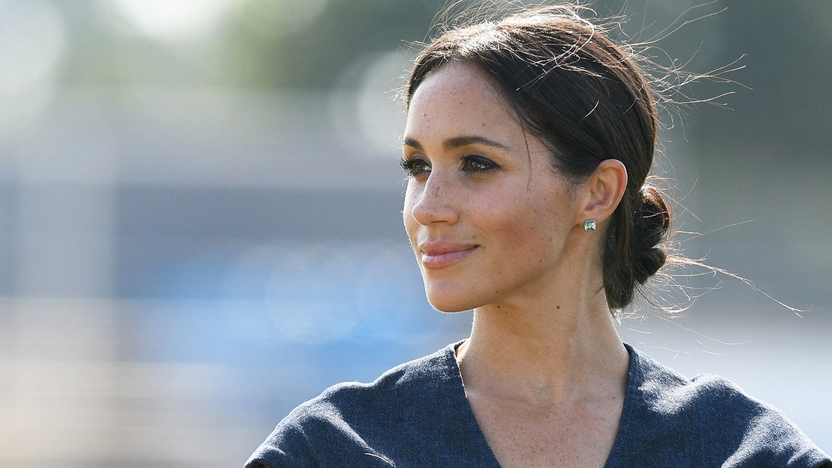 A close-up photo of Meghan Markle looking away from the camera