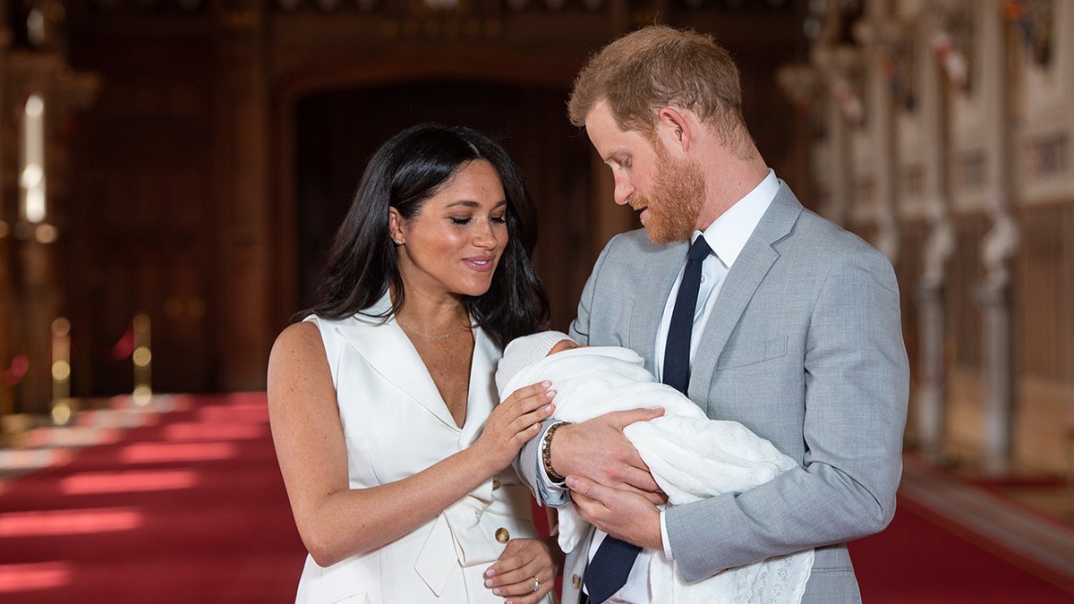 The Duke and Duchess of Sussex holding their newborn son Archie