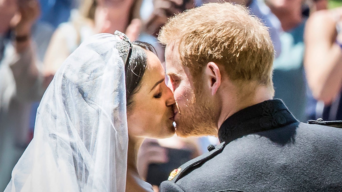 Prince Harry kissing bride Meghan Markle on their wedding day