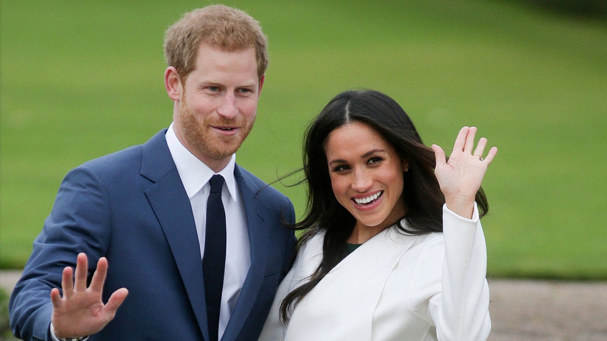 Prince Harry and Meghan Markle waving during their engagement