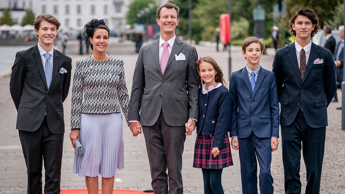 Prince Joachim of Denmark with his family outside posing for cameras