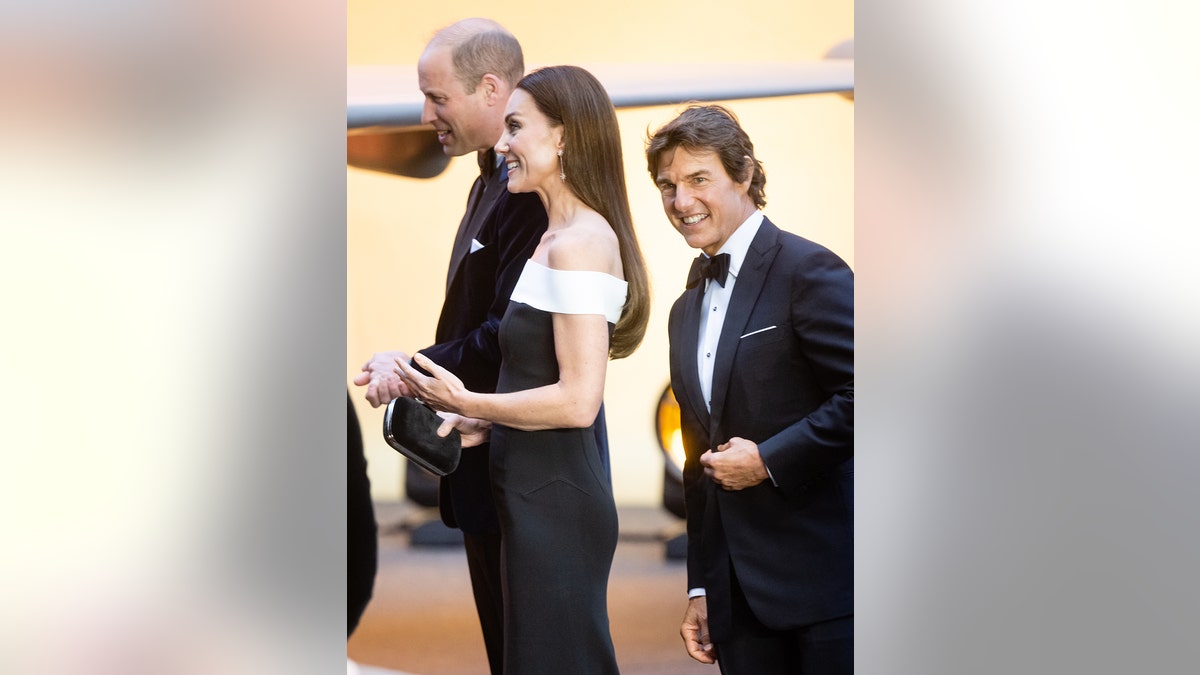 Tom Cruise standing behind Prince William and Kate Middleton at the Top Gun premiere in London