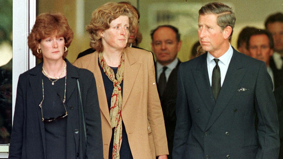 Princess Diana's sisters standing next to Prince Charles following the death of their sibling