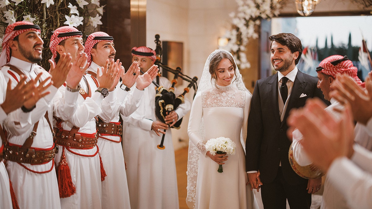 Princess Iman of Jordan and Jameel Alexander Thermiotis walking down the aisle