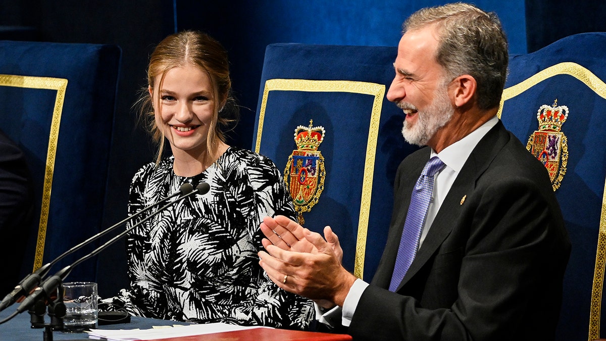 Princess Leonor of Spain applauding alongside her father the king