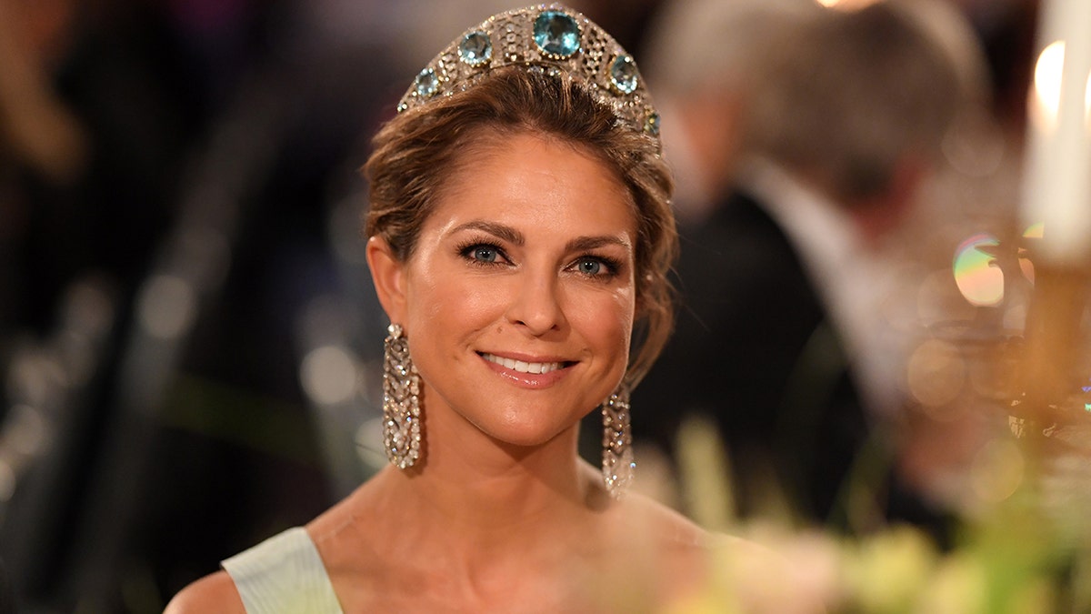 Princess Madeleine of Sweden wearing a light green dress and a tiara