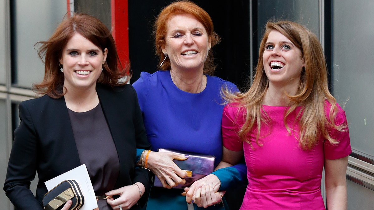 Sarah Ferguson holding onto her two daughters