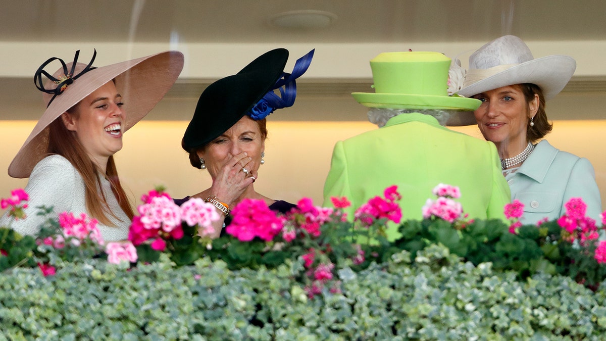 Sarah Ferguson laughing with her daughter Princess Beatrice as they stand next to Queen Elizabeth II