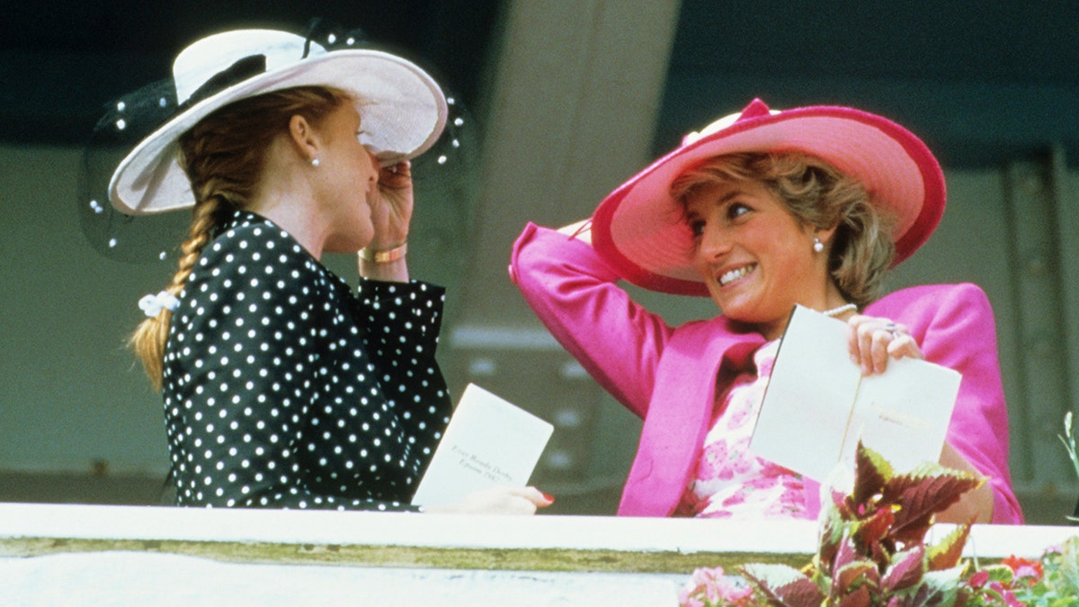 Sarah Ferguson and Princess Diana laughing at each other during the Epsom Derby Match
