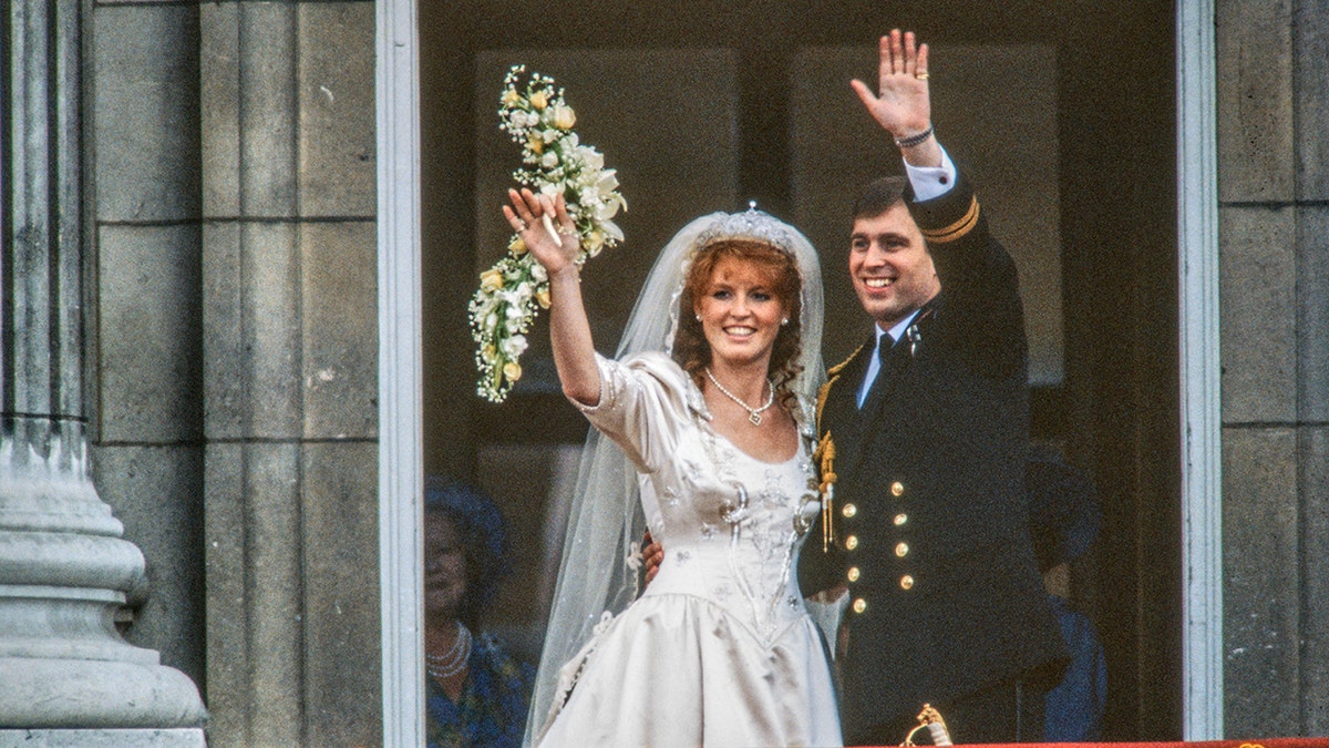 Sarah Ferguson wearing a bridal gown next to her husband Prince Andrew