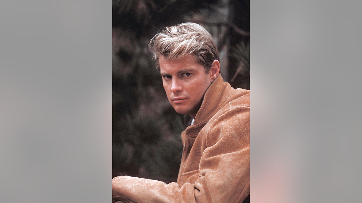 Troy Donahue posing for a portrait in a leather jacket
