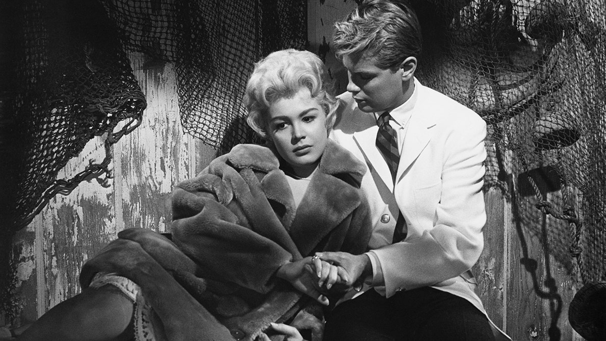 Sandra Dee and Troy Donahue holding hands in the 1959 A Summer Place.