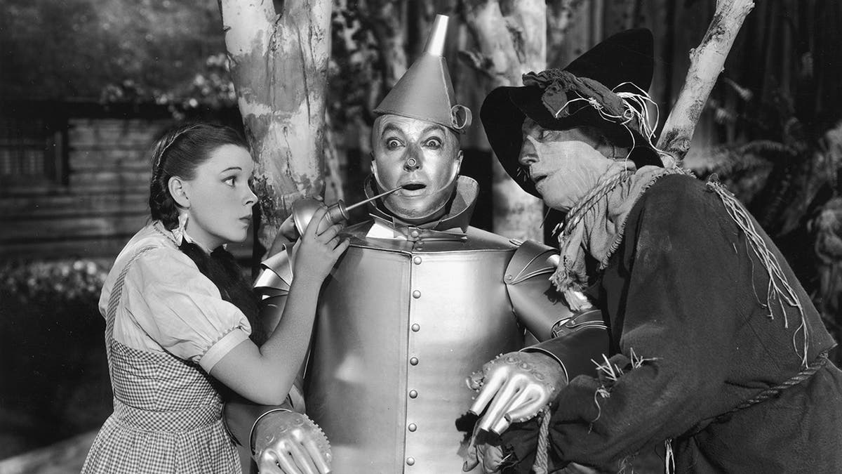 Jack Haley in a scene from The Wizard of Oz with Judy Garland and Ray Bogler in costume