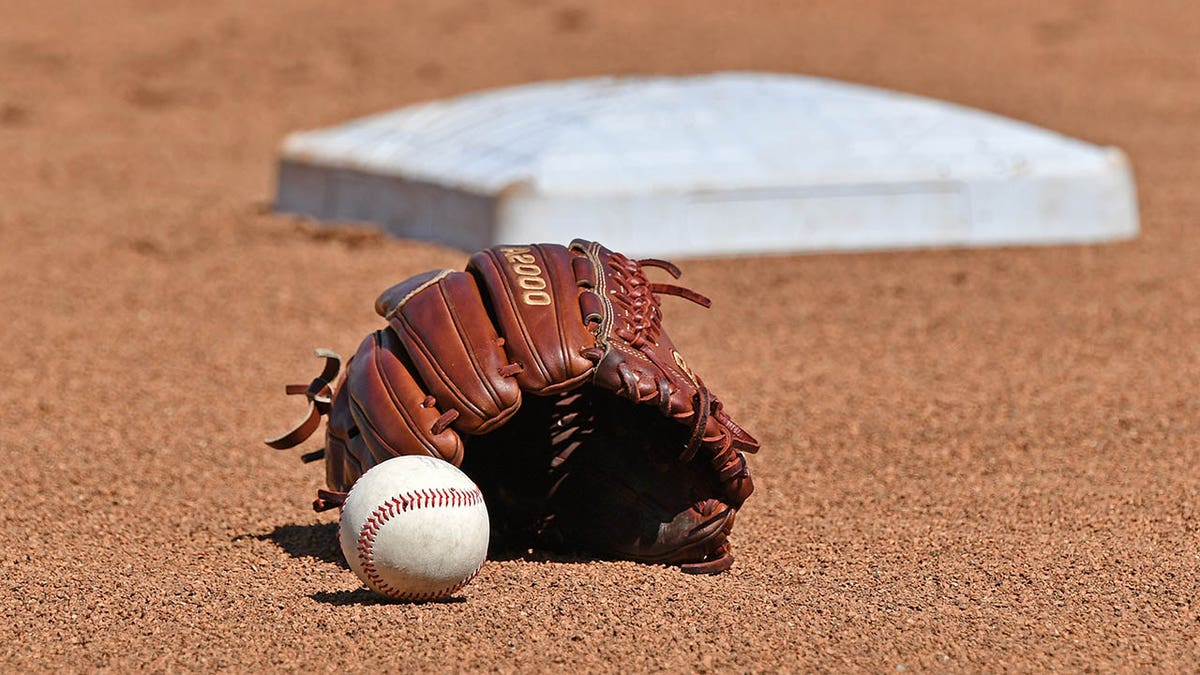 A baseball glove in the dirt