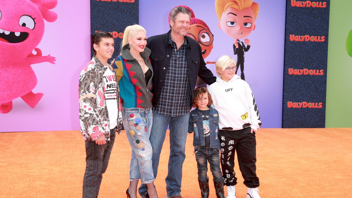 Gwen Stefani walks red carpet with Blake Shelton and her children