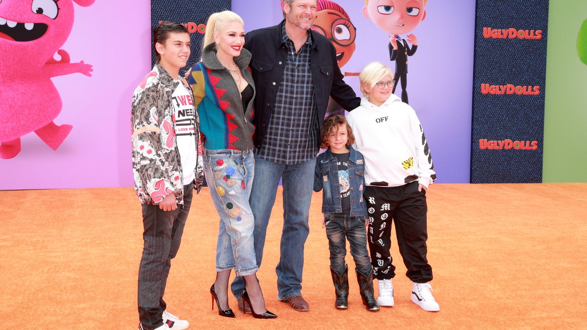 Gwen Stefani walks red carpet with Blake Shelton and her children