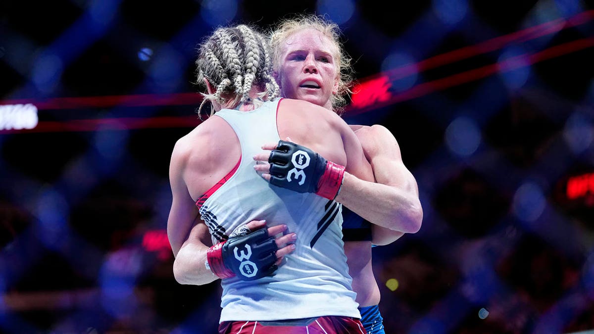 Holly Holm hugs Yana Santos