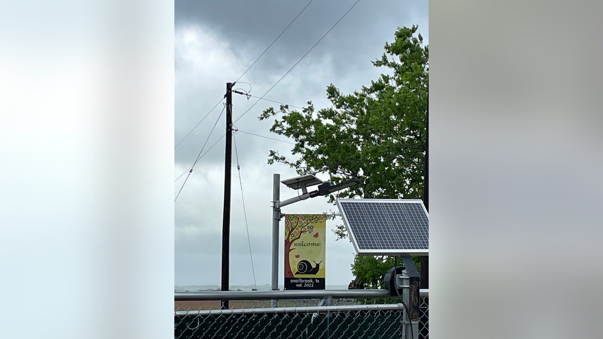 A Snailbrook-related lamppost next to a Boring Co. facility in Bastrop, TX, is pictured.