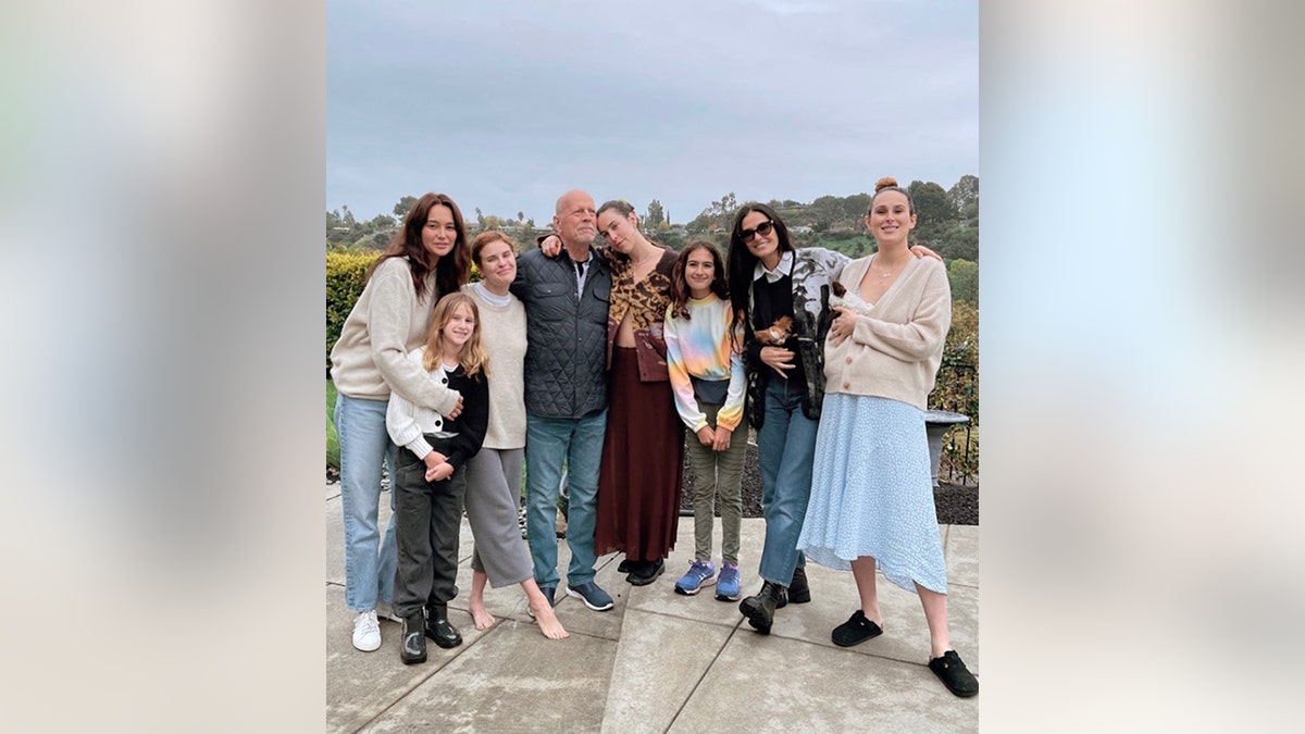 Bruce Willis is surrounded by his family outside on the patio for his birthday, from left Emma, Evelyn, Tallulah, Bruce, Scout, Mabel, Demi, and Rumer