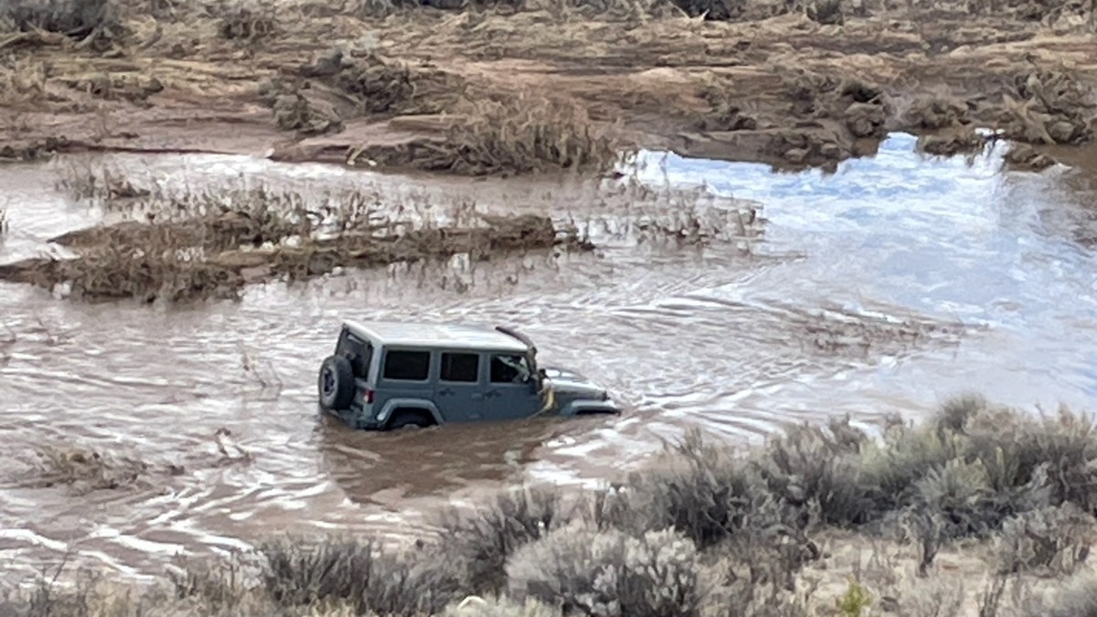 The Jeep stuck in floodwaters