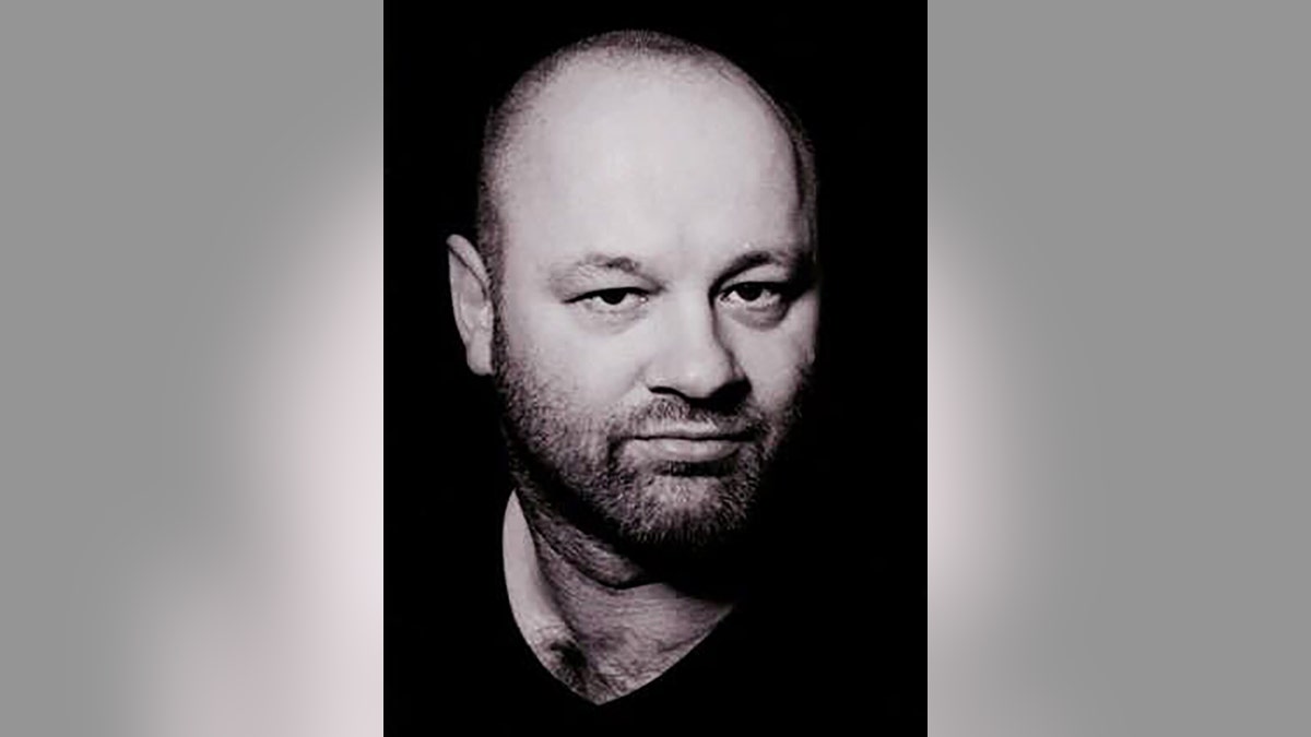 A close-up black and white photo of Dean Jenkins