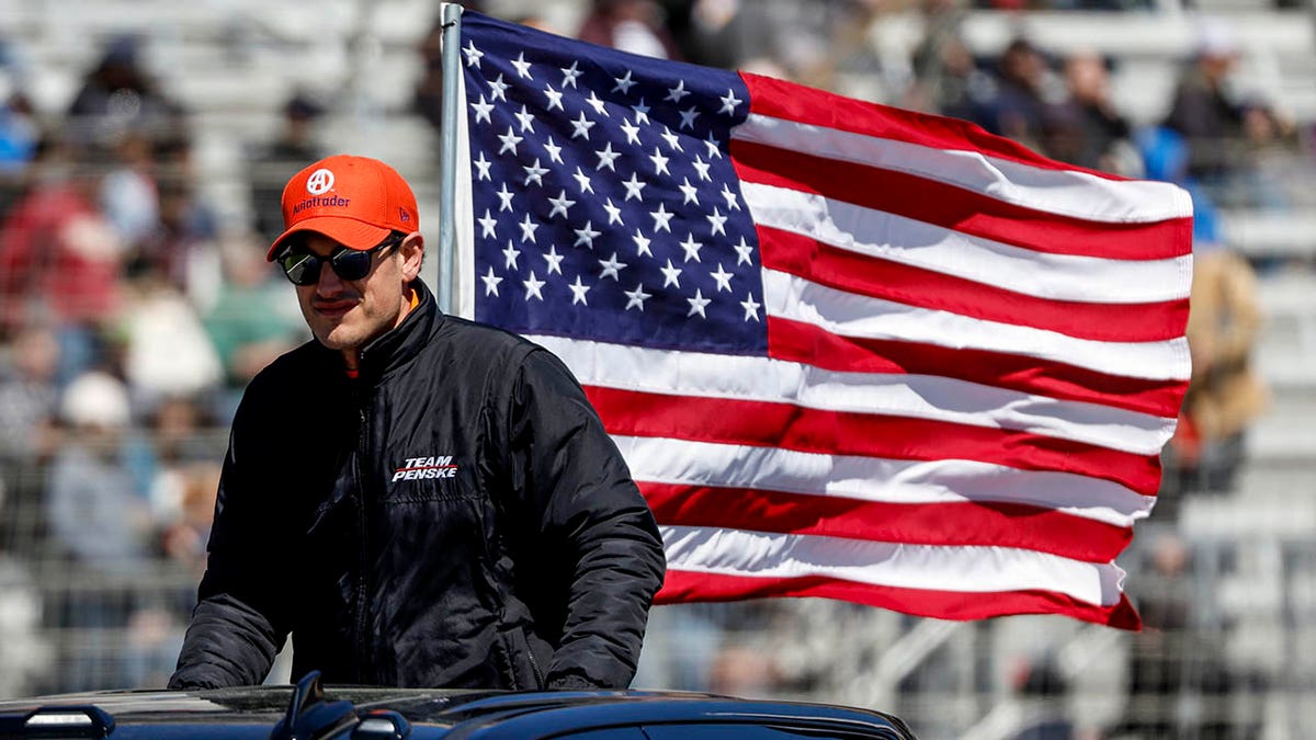 Joey Logano rides to his car