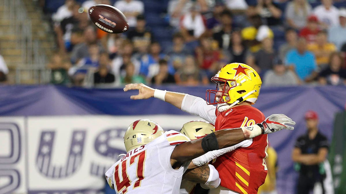 KJ Costello throws a pass