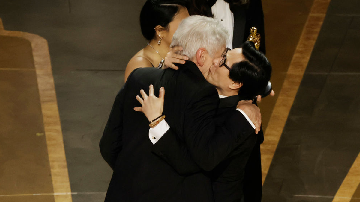Ke Huy Quan and Harrison Ford embrace