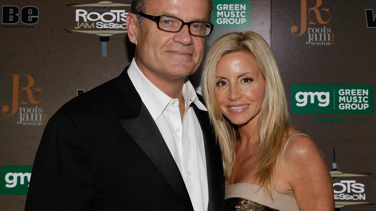 Kelsey Grammer smiles alongside Camille Grammer on red carpet